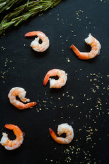 Fototapeta na wymiar Abstract seafood shrimps on dark background. Good source of omega 3 acid unsaturated fats.