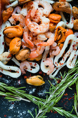Seafood mix on dark background. Asian cuisine. Healthy eating. Diet food concept
