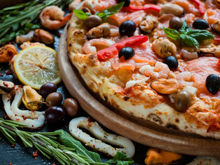 Mediterranean pizza with seafood and olives. Classical italian recipe concept
