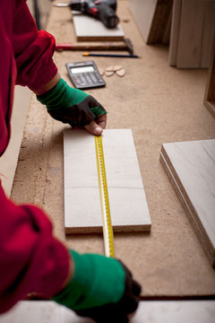 carpenter  with yardstick in workshop