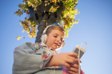 happy girl child listen to the music from her smartphone