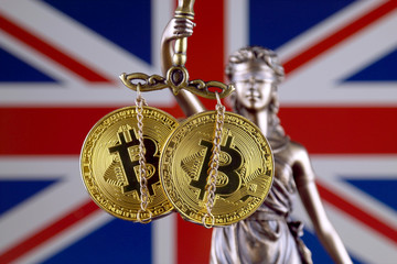Symbol of law and justice, physical version of Bitcoin and United Kingdom Flag. Prohibition of cryptocurrencies, regulations, restrictions or security, protection, privacy.