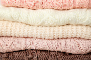 Fototapeta na wymiar Stack of knitted sweaters background