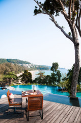 Dinner table by the pool with ocean view in Phuket, Thailand - obrazy, fototapety, plakaty