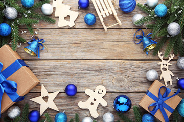 Fir-tree branches with christmas decorations on wooden table