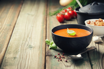 Homemade tomato soup (or gazpacho) over old wooden background