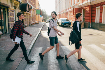 urban teenage hipster street lifestyle. students go to college or high school to study. crosswalk traffic laws concept