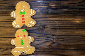 Christmas gingerbread couple cookies on wooden table. Top view
