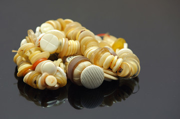 Group of buttons for clothing on a black background.