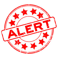 Grunge red alert word with star icon round rubber seal stamp on white background
