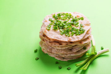 Indian flatbread chapati, green onion. Color surge trend.