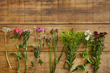 graphic arrangement of wild flowers on wooden table