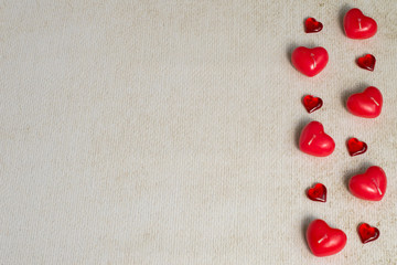 Valentine's Day. Small candles in the form of red hearts on a light background with copy space. Top view.