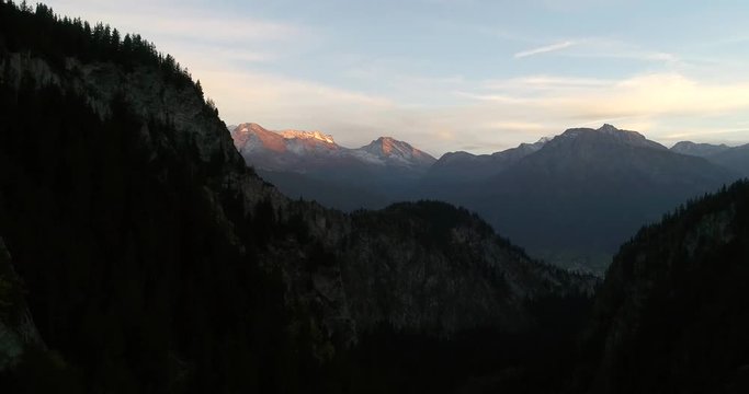 Alpine landscape, Cinema 4k aerial rising view over a mountain town, on a sunny autumn evening dawn, in blatten,,Valais, in the alps of Switzerland
