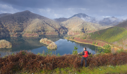 Hiker admiring the landscape in the AÃ±arbe reservoir, Gipuzkoa