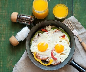 fried eggs with vegetables for breakfast