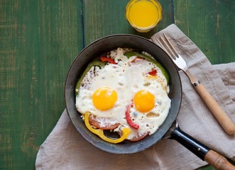 fried eggs with vegetables for breakfast
