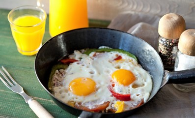 fried eggs with vegetables for breakfast