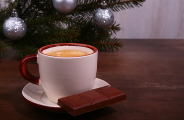 Coffee cup and chocolate on wooden table texture. Coffeebreak. Christmas time