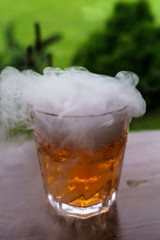 A glass of steaming champagne, on the table.