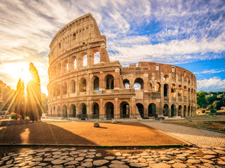 Fototapeta na wymiar Colosseum at sunrise, Rome, Italy, Europe. Rome ancient arena of gladiator fights. Rome Colosseum is the best known landmark of Rome and Italy
