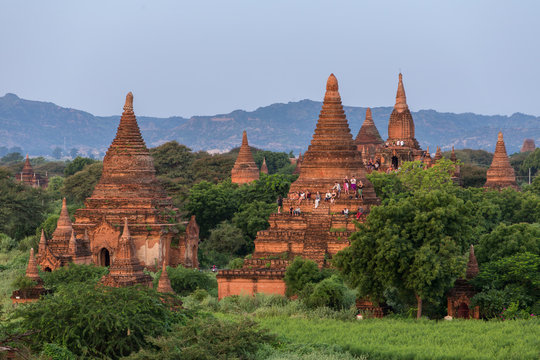 Bagan, Myanmar - October 11, 2016:  Tourists watching  sunrise climbed up at the ancient pagodas in Bagan, Myanmar.