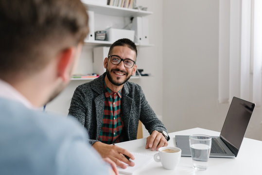 Company recruiter warmly welcomes a job candidates at a job interview