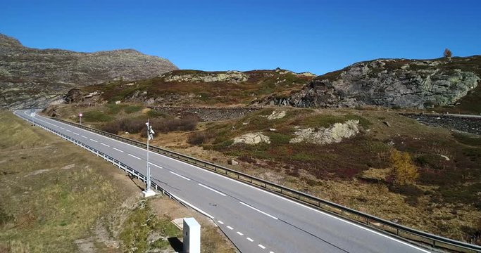 Alpine town, Cinema 4k aerial view over a mountain, revealing a alp village, on the top of simplon pass, on a sunny autumn evening, in Ticino, in Switzerland