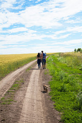Obraz premium A man and a girl are embracing along a country road