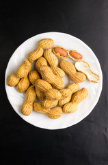 Peanuts in shell on dark background, close up