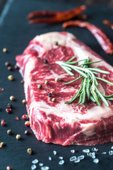 Raw beef steak with fresh rosemary