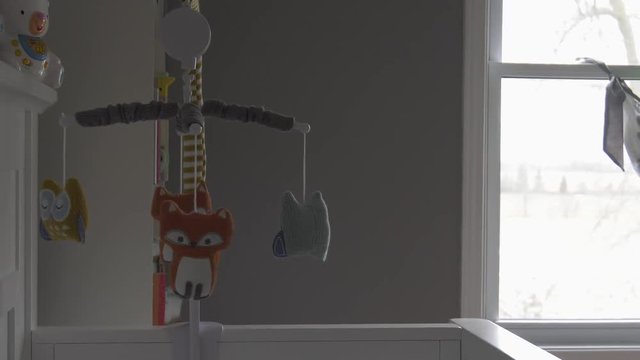forest themed mobile spinning in baby nursery autumn setting outside 4k