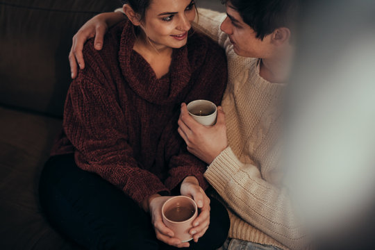 Affectionate couple at home with coffee