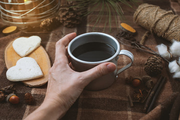 picnic in nature, hands holding a cup of coffee, plaid and hearts