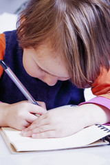 little beautiful child girl learns to write (preschool, development, training, education concept)