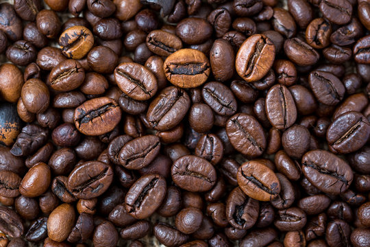 Fried coffee beans background. Macro