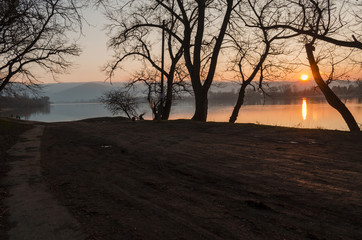 winter sunset on beach in Hungary, calm country side river sunset