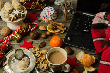 Fototapeta na wymiar Christmas and new year holiday celebration concept background. Cup of hot cocoa with homemade Christmas cookies, Xmas decoration on wooden table. Cozy Christmas at home. Christmas holidays composition