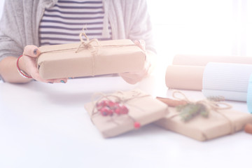 Hands of woman holding christmas gift box.