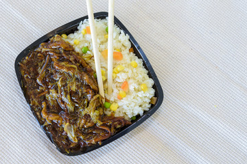 A mixture of Chinese food with rice and peanuts