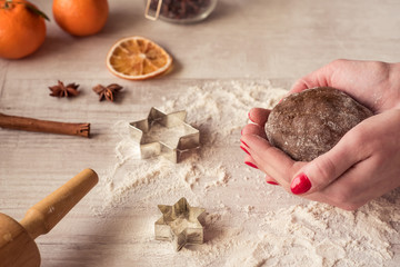 Female hands making gingerbread cookies for Christmas.