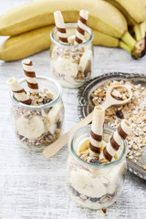 Layer dessert with muesli, chocolate and banana fruits.