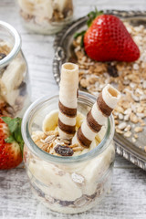 Layer dessert with muesli, chocolate and banana fruits.