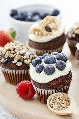 Muffins decorated with fresh fruits.