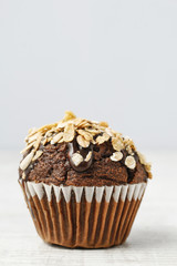 Chocolate muffin with oatmeal flakes.