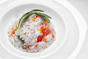 Tasty boiled rice with vegetables on plate, closeup