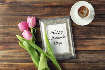 Pink tulips, cup of coffee and photo frame with words 