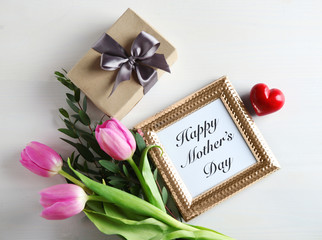 Gift box, pink tulips and photo frame with words 