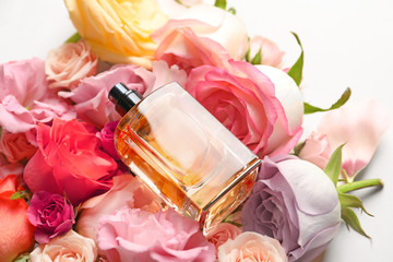 Bottle of perfume on beautiful flowers