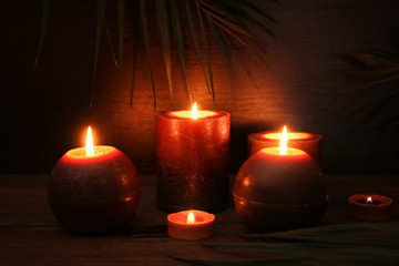 Fototapeta na wymiar Many burning candles on table